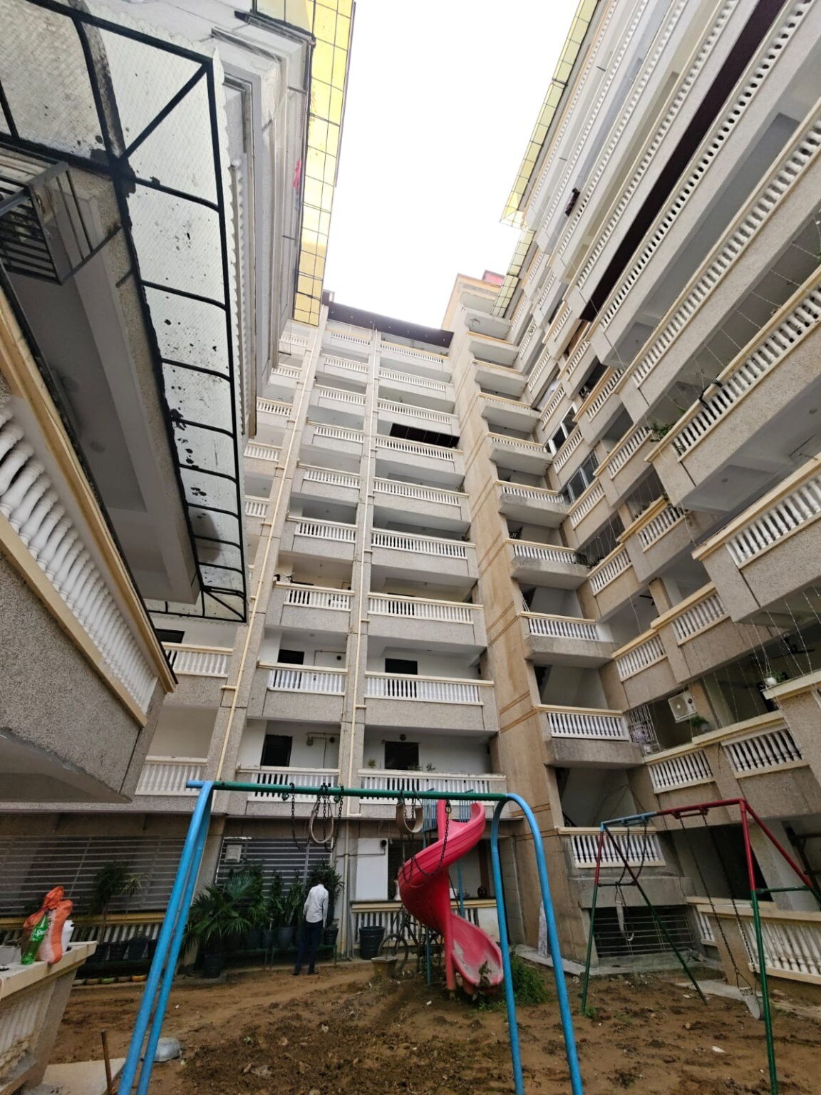 Courtyard view of completed additional-floor work at Mahavir CGHS