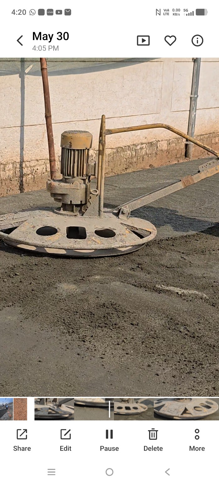 Power trowel surface finishing on M25 road concrete